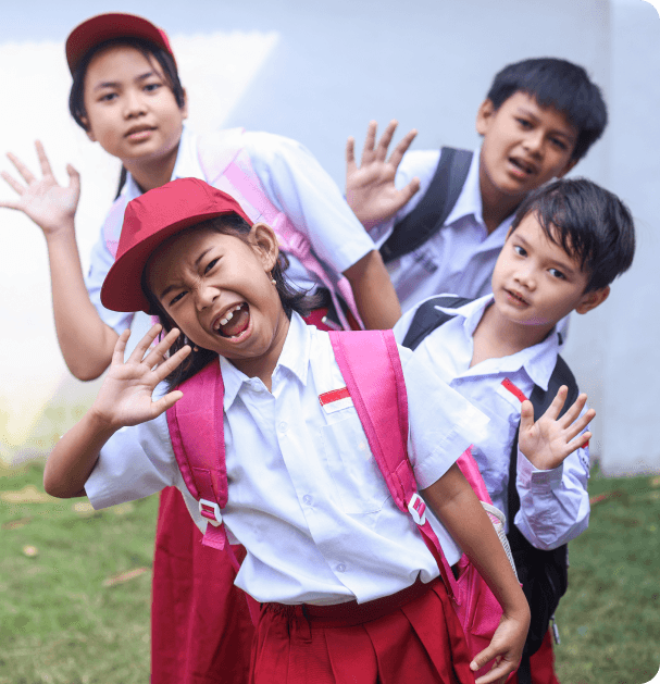 Children smiling and waving